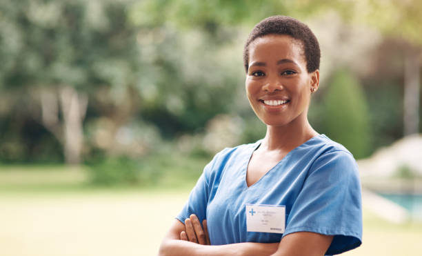 Portrait of a confident young nurse standing outside in the garden of a retirement home.